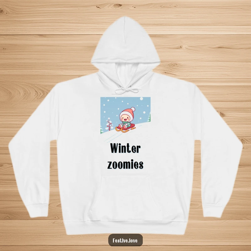 Funny, warm hoodie featuring a character having a blast sledding down a snowy landscape on a festive sled, embodying pure winter delight.