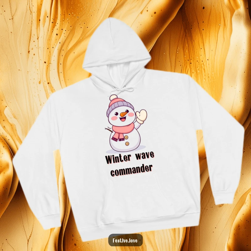 Funny kawaii snowman with a carrot nose, energetically waving a mitten, featured on a warm and soft hoodie.